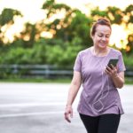 lady checking her phone on an outdoorspower walk