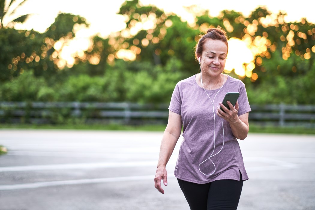 lady checking her phone on an outdoorspower walk